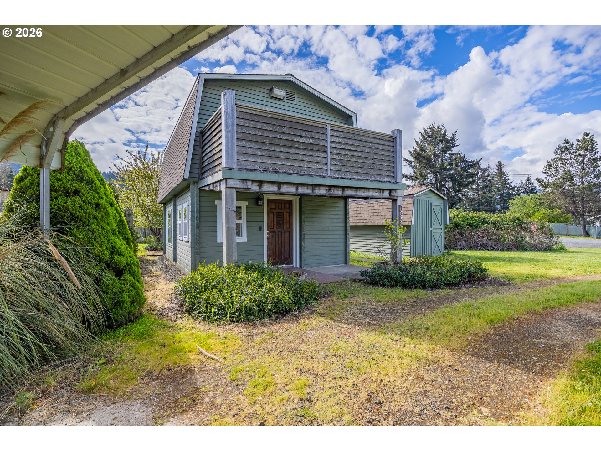 1250 North 3rd Avenue Powers, OR 97466 - Photo 1 of 48 a front view of a house with garden