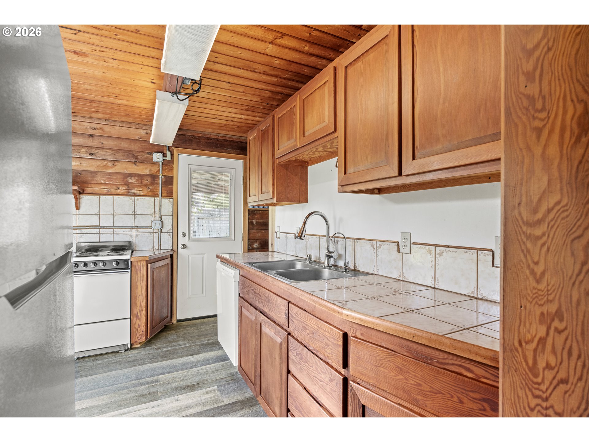 1250 North 3rd Avenue Powers, OR 97466 - Photo 18 of 48 a kitchen with stainless steel appliances granite countertop a sink stove and cabinets