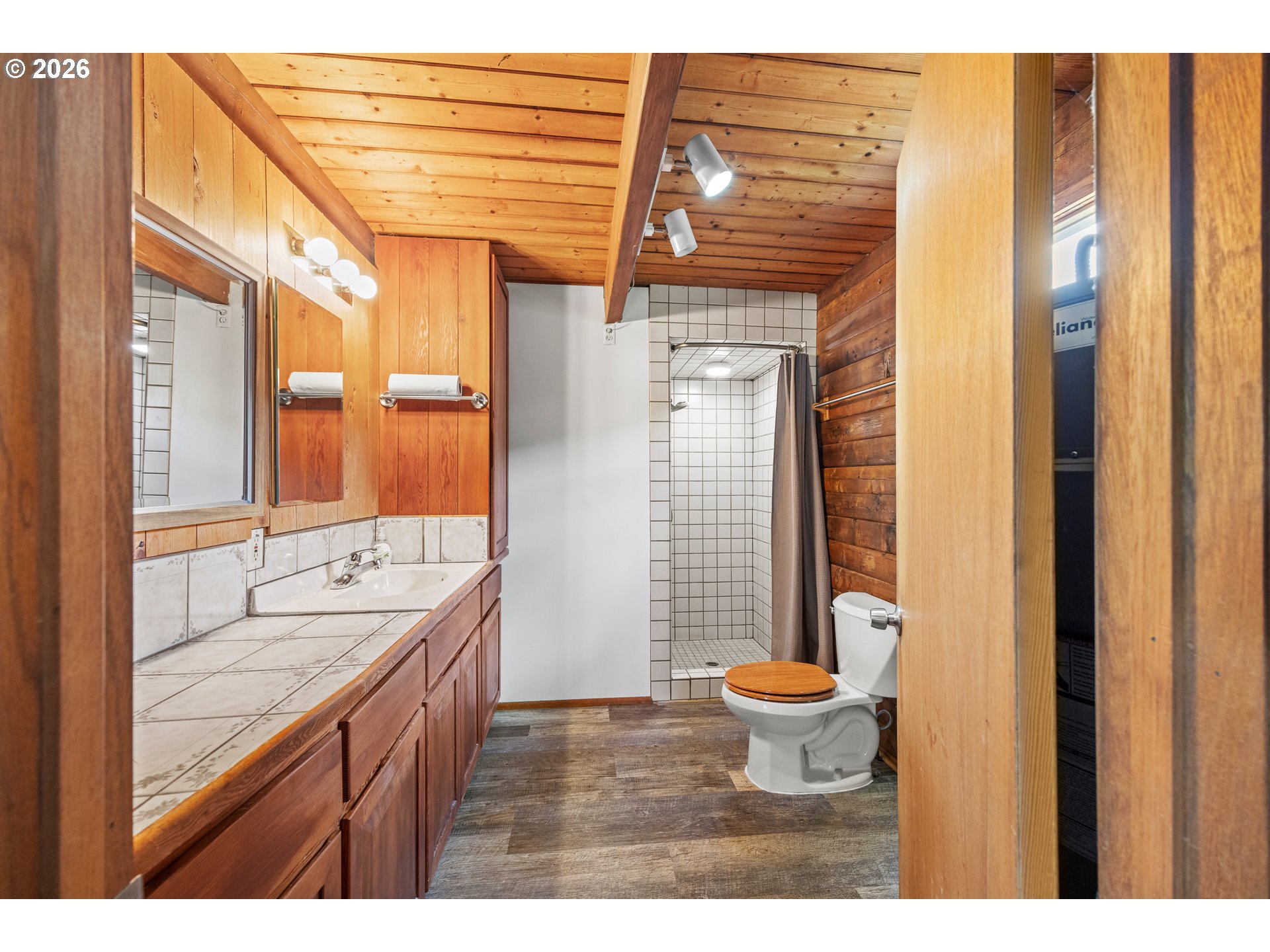 1250 North 3rd Avenue Powers, OR 97466 - Photo 24 of 48 a bathroom with a granite countertop sink and a large mirror
