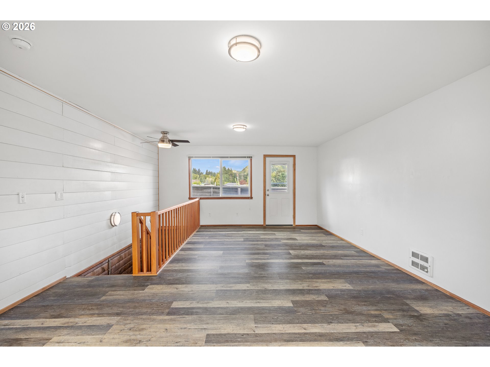 1250 North 3rd Avenue Powers, OR 97466 - Photo 29 of 48 a view of an empty room with wooden floor and windows