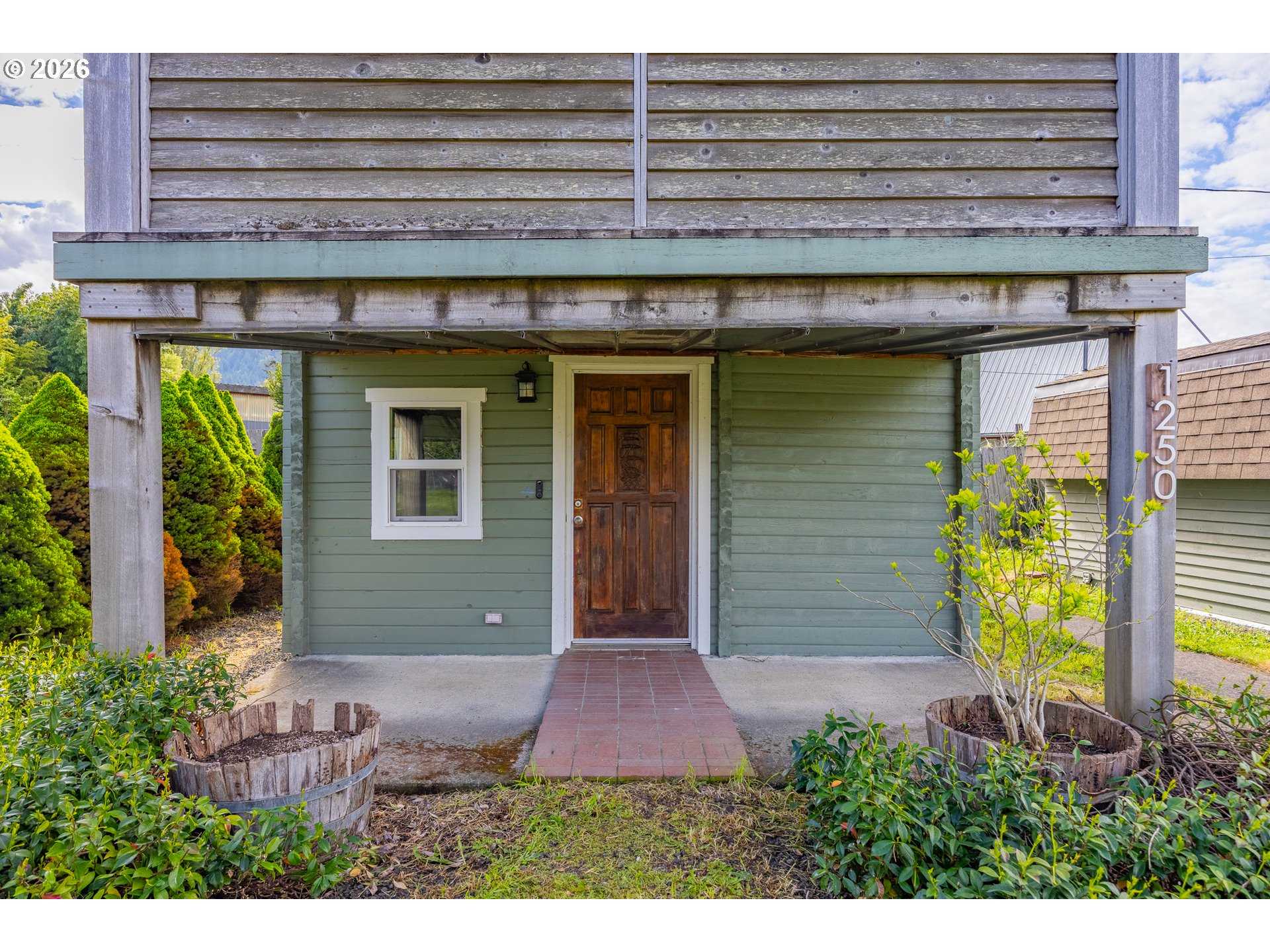 1250 North 3rd Avenue Powers, OR 97466 - Photo 3 of 48 a front view of a house with garden