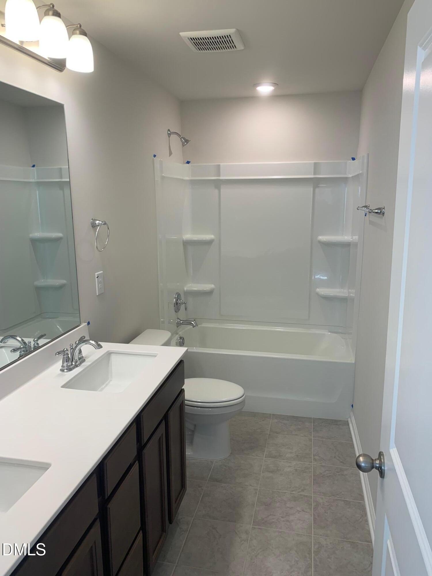 422 Diversity Way Raleigh, NC 27610 - Photo 3 of 10 a bathroom with a sink a toilet and shower