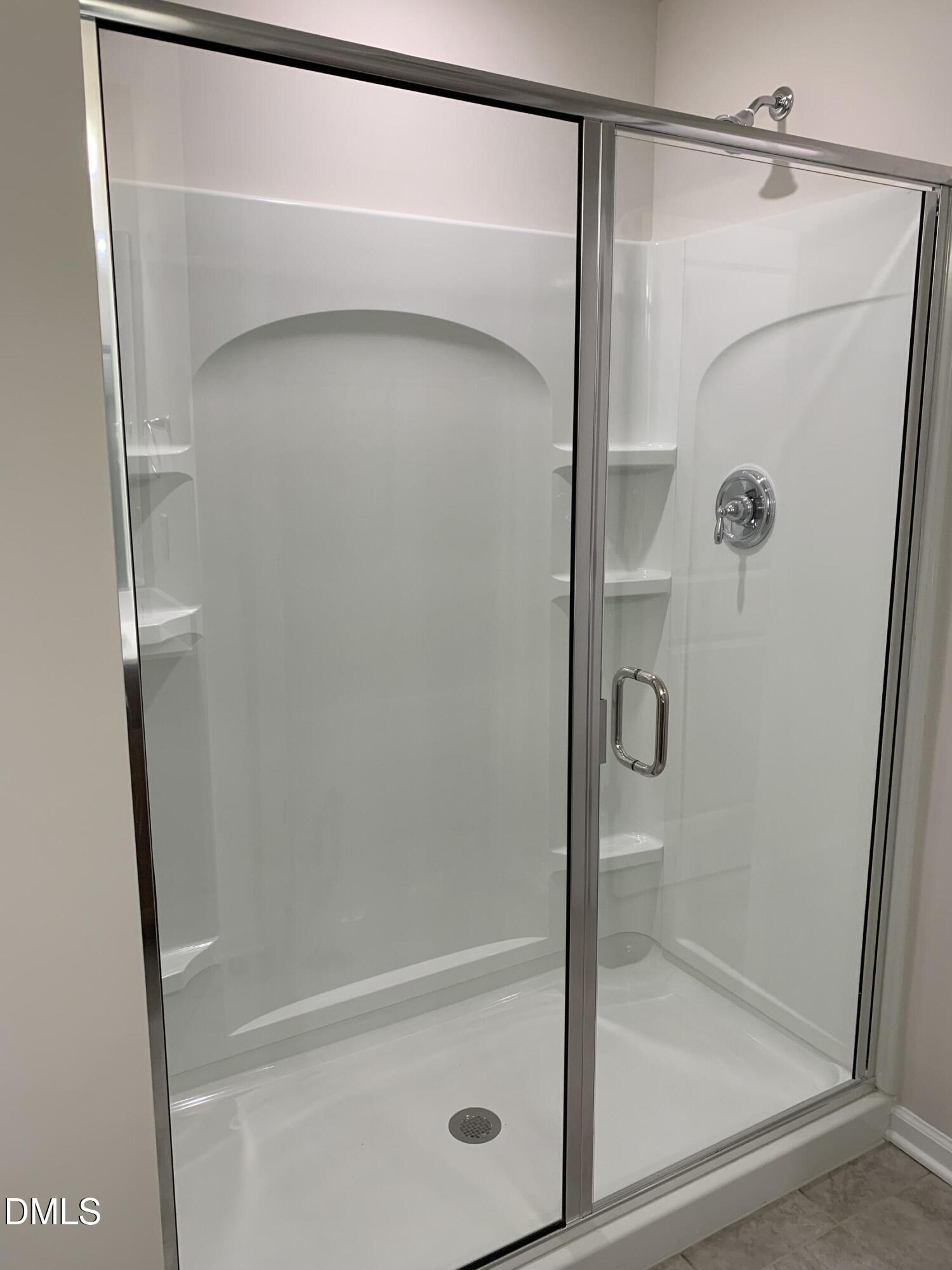422 Diversity Way Raleigh, NC 27610 - Photo 7 of 10 a bathroom with a glass shower door