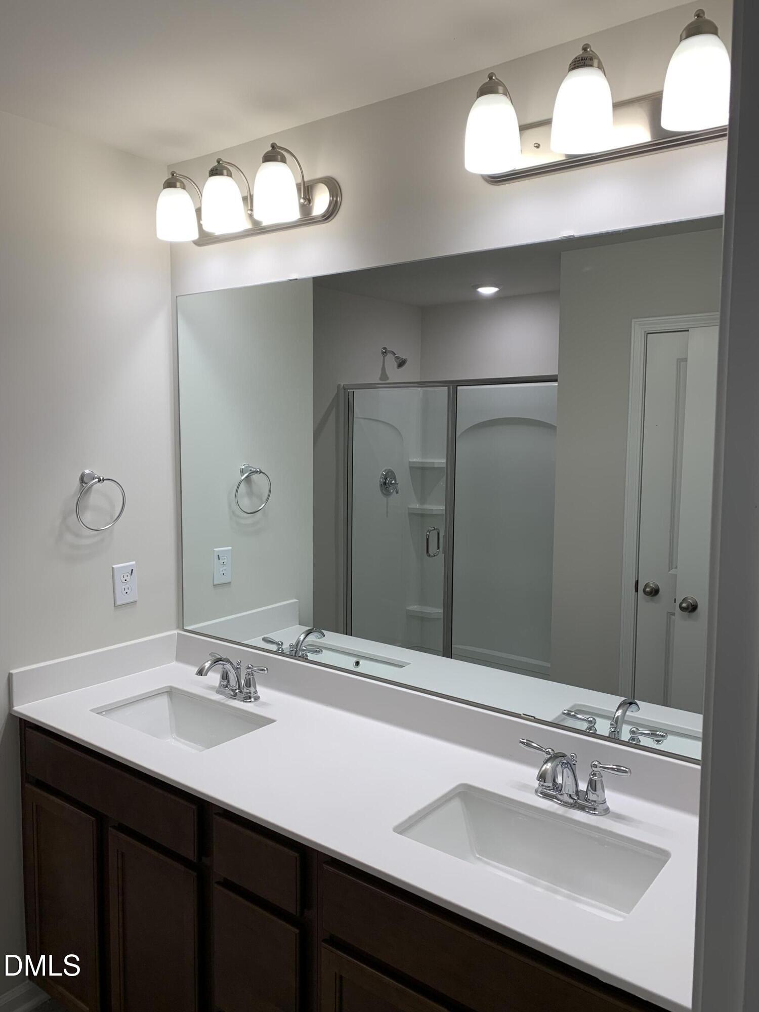 422 Diversity Way Raleigh, NC 27610 - Photo 9 of 10 a bathroom with a sink vanity and a mirror