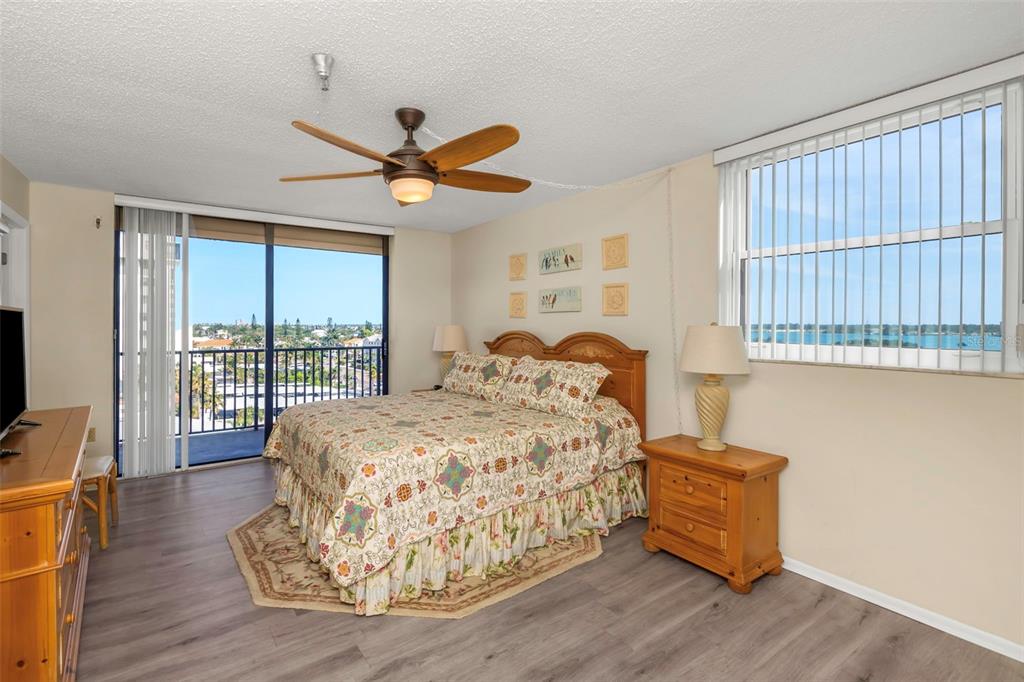 15316 Gulf Boulevard, Unit 604 Madeira Beach, FL 33708 - Photo 28 of 82 a bedroom with a bed and a large window