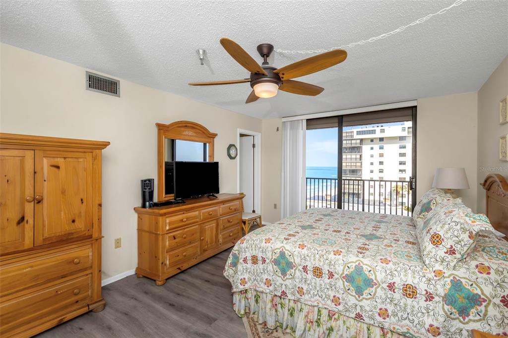 15316 Gulf Boulevard, Unit 604 Madeira Beach, FL 33708 - Photo 29 of 82 a bedroom with a bed and a flat screen tv