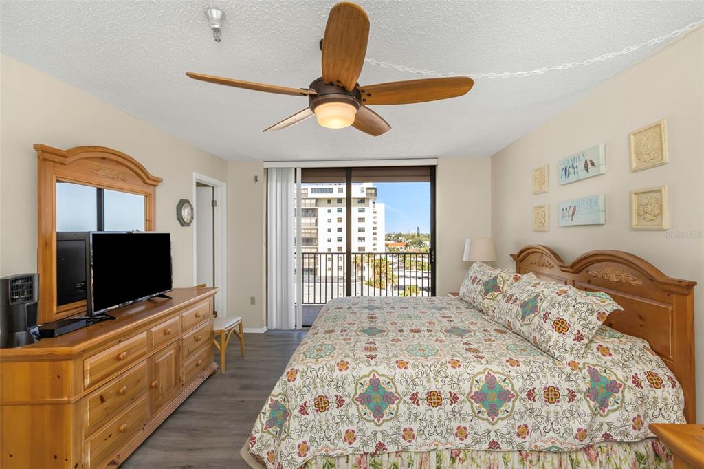 15316 Gulf Boulevard, Unit 604 Madeira Beach, FL 33708 - Photo 31 of 82 a bedroom with a bed and a flat screen tv