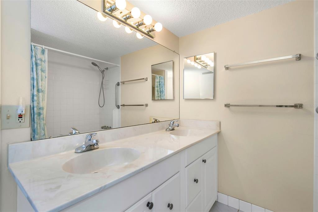 15316 Gulf Boulevard, Unit 604 Madeira Beach, FL 33708 - Photo 34 of 82 a bathroom with a sink and a mirror