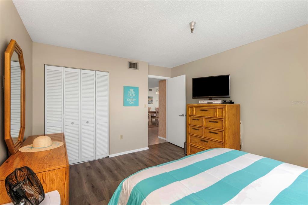 15316 Gulf Boulevard, Unit 604 Madeira Beach, FL 33708 - Photo 38 of 82 a bedroom with a bed and wooden floor