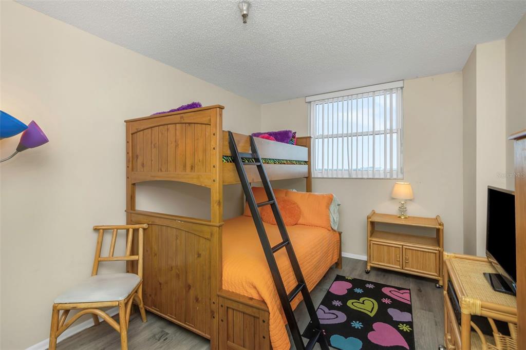 15316 Gulf Boulevard, Unit 604 Madeira Beach, FL 33708 - Photo 40 of 82 a bedroom with a bed and a window