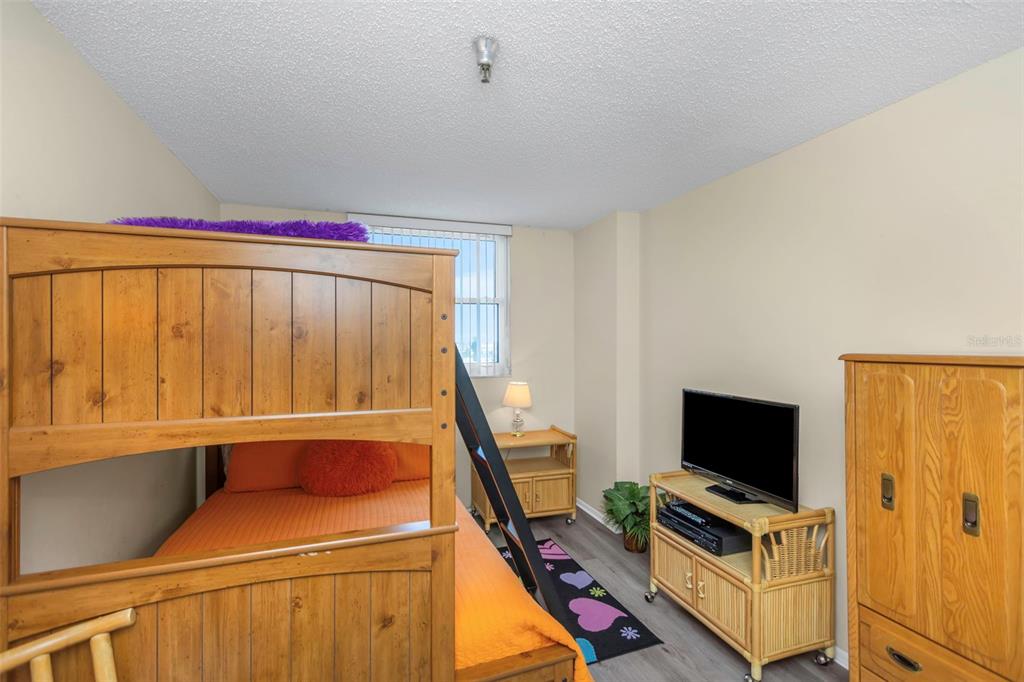 15316 Gulf Boulevard, Unit 604 Madeira Beach, FL 33708 - Photo 41 of 82 a room with furniture and a flat screen tv