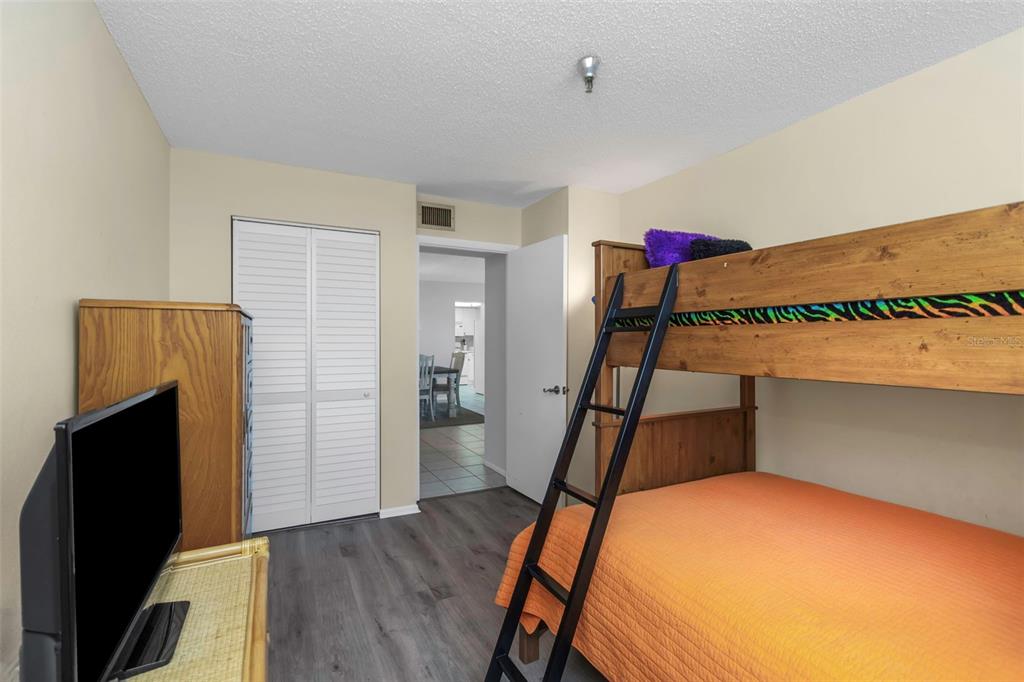 15316 Gulf Boulevard, Unit 604 Madeira Beach, FL 33708 - Photo 42 of 82 a bedroom with a bed and wooden floor