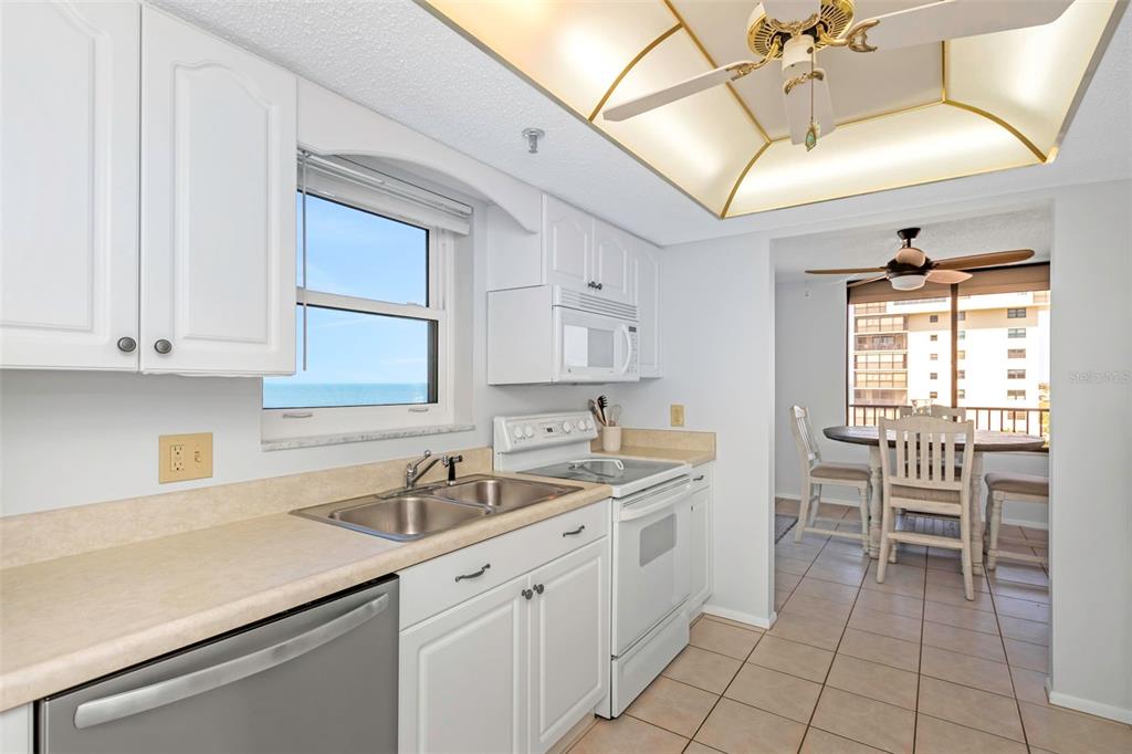 15316 Gulf Boulevard, Unit 604 Madeira Beach, FL 33708 - Photo 7 of 82 a kitchen with a sink cabinets and window