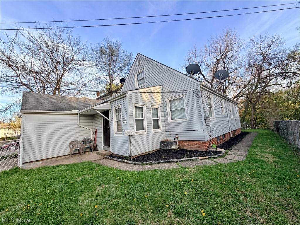 10506 Park Heights Road Cleveland, OH 44104 - Photo 3 of 22 Light blue vinyl siding exterior with an asphalt shingle roof