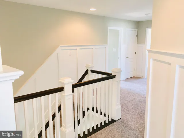 a view of a livingroom with a fireplace wooden floor and windows