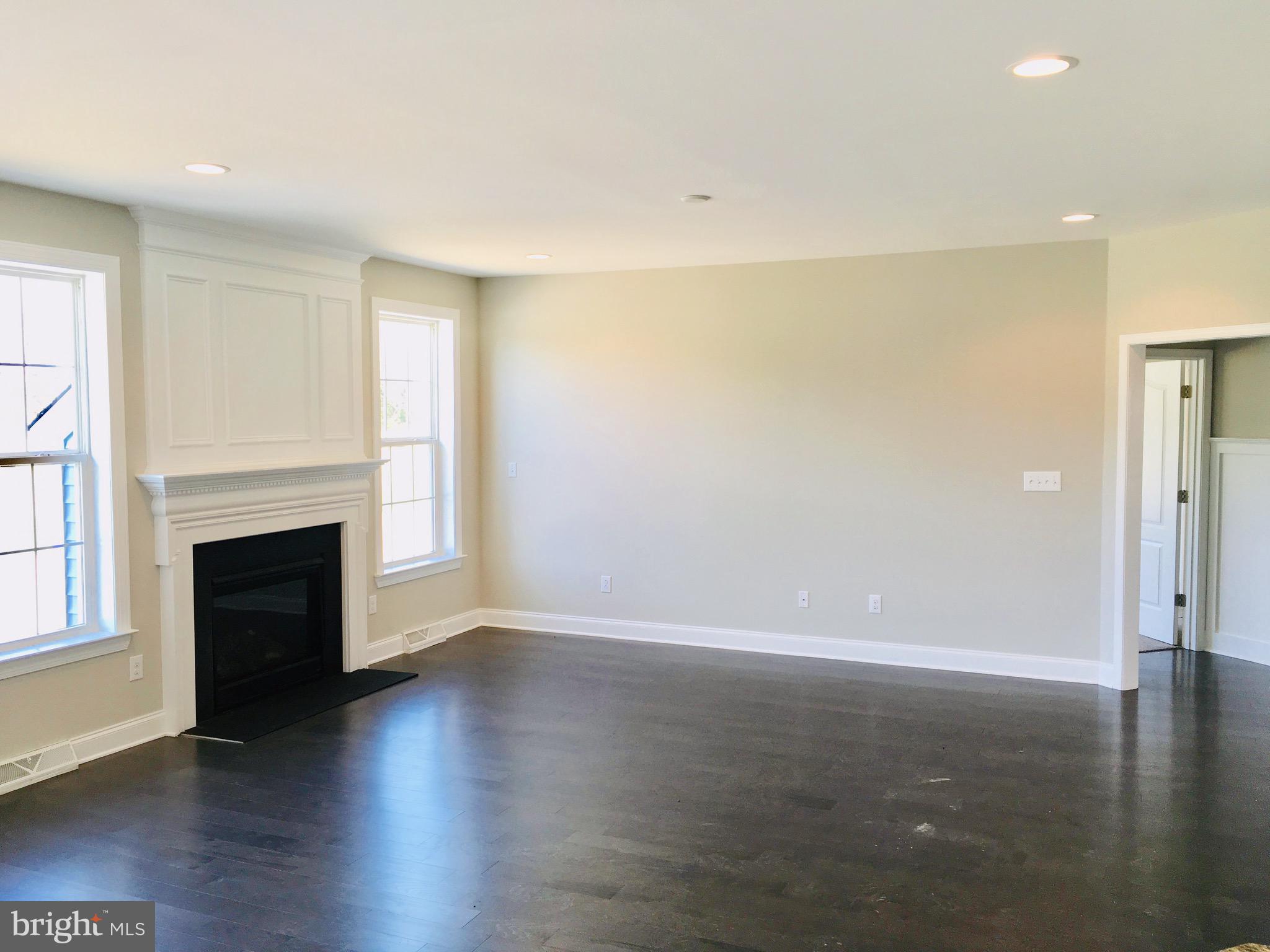 9 Patriots Way Georgetown, DE 19947 - Photo 14 of 67 a view of a livingroom with a fireplace wooden floor and windows