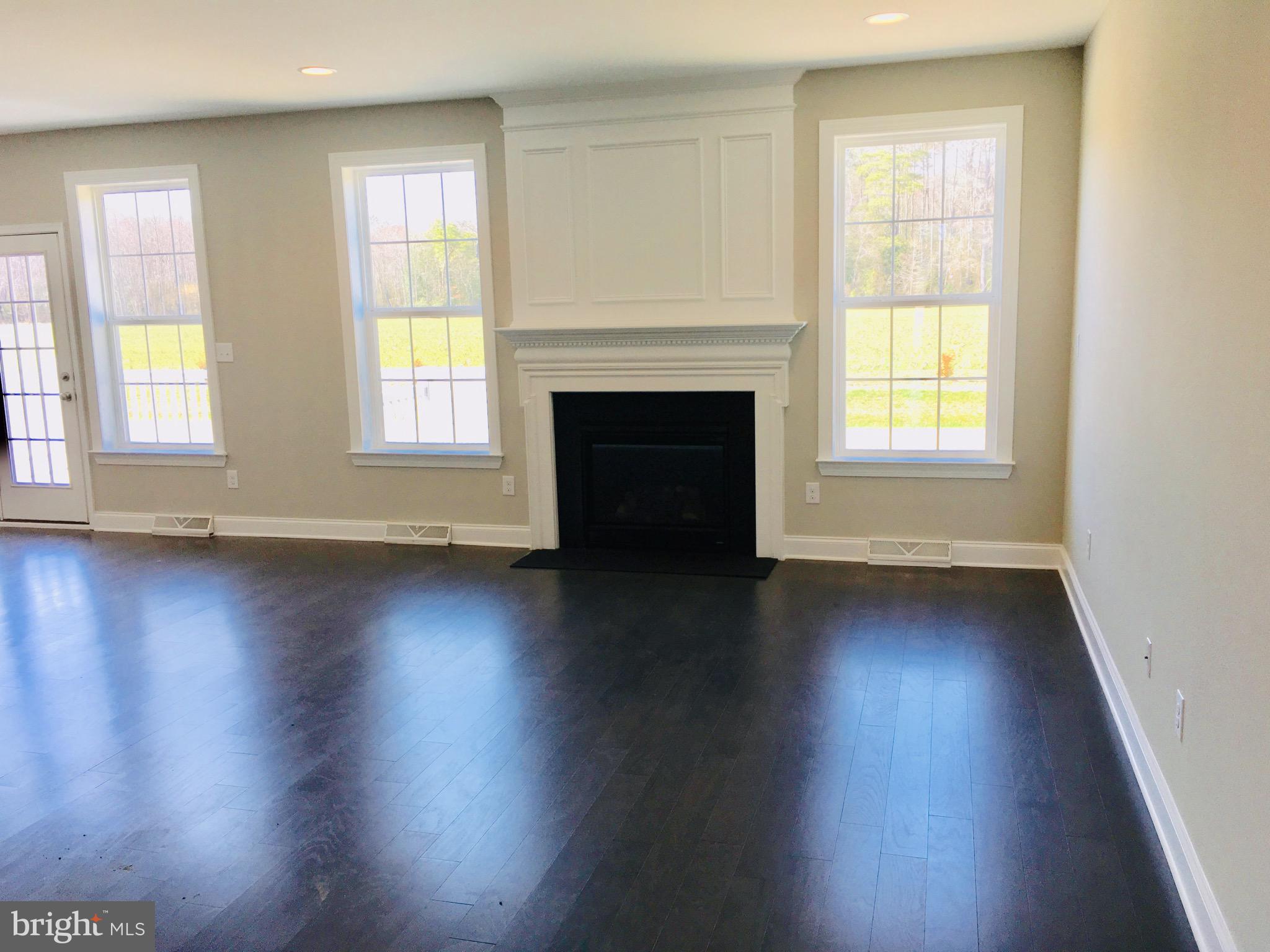 9 Patriots Way Georgetown, DE 19947 - Photo 17 of 67 an empty room with wooden floor and a window