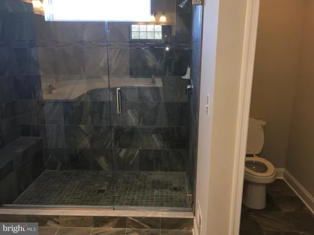 a kitchen with stainless steel appliances granite countertop a sink a stove and a microwave