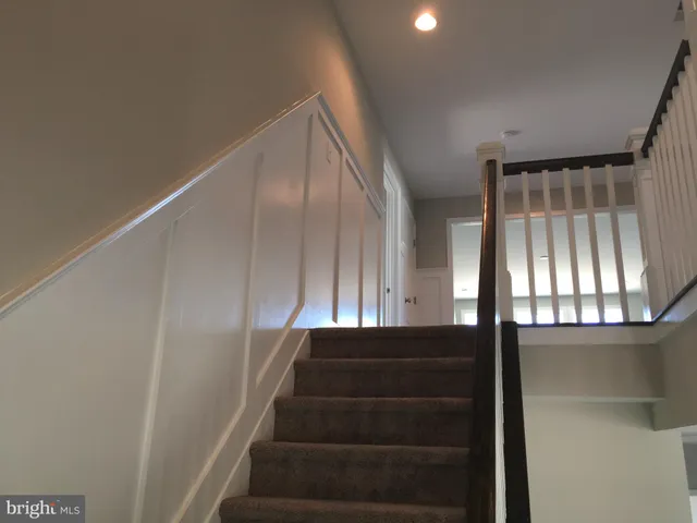 wooden floor fireplace and windows in an empty room