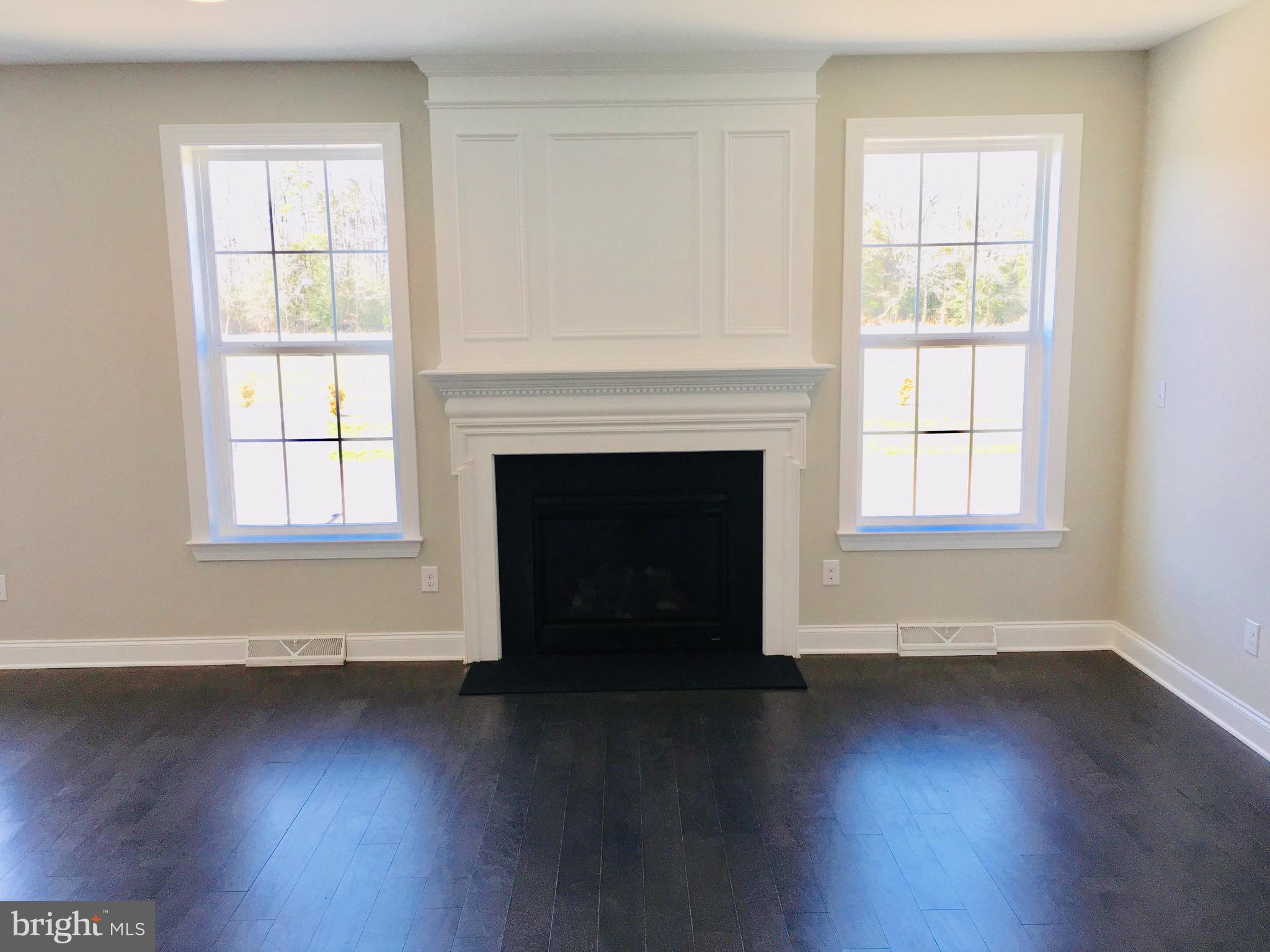 9 Patriots Way Georgetown, DE 19947 - Photo 59 of 67 wooden floor fireplace and windows in an empty room