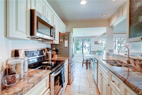 a bathroom with a sink vanity granite shower and a mirror