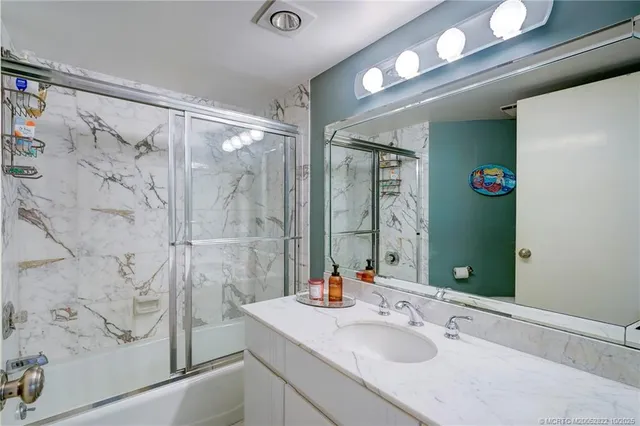 a bathroom with a double vanity sink and a mirror
