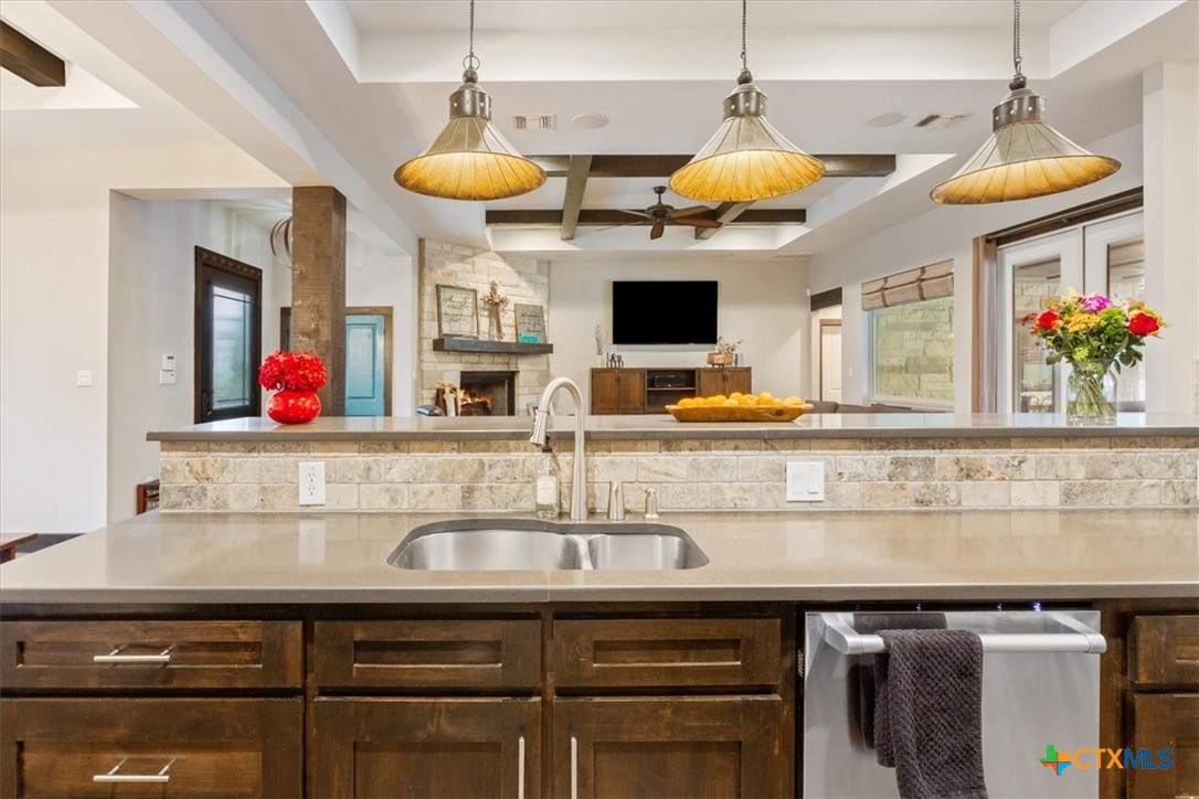 569 Messer Ranch Road Belton, TX 76513 - Photo 11 of 48 a kitchen with a sink and a flat screen tv