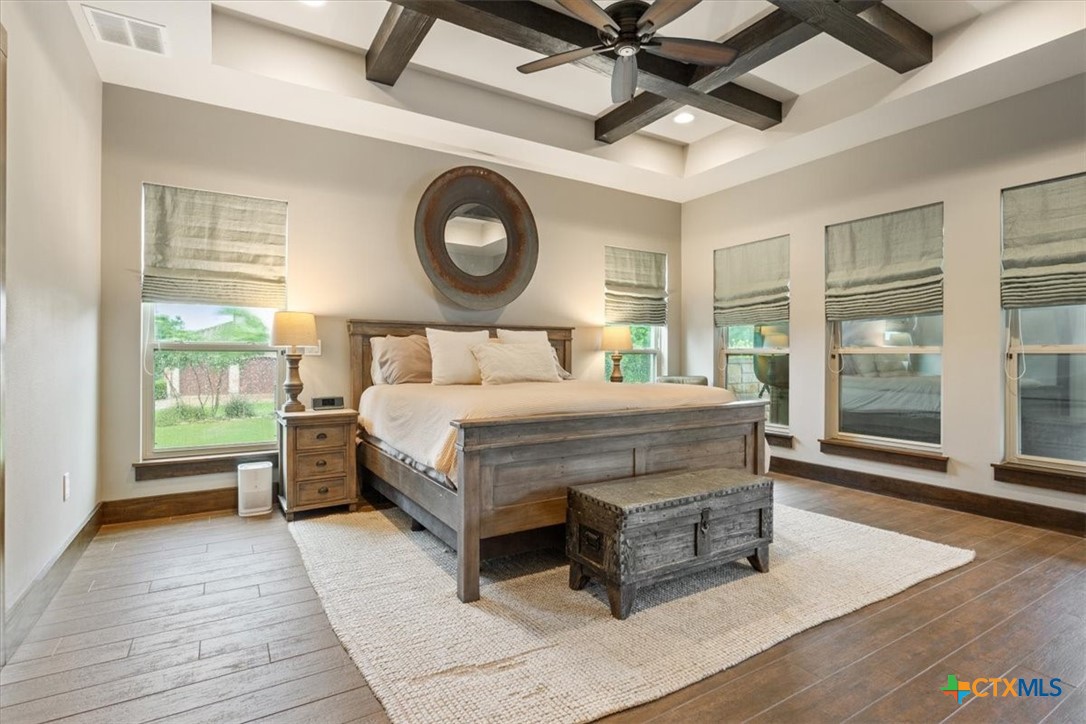 569 Messer Ranch Road Belton, TX 76513 - Photo 15 of 48 a bedroom with a large bed and a large window