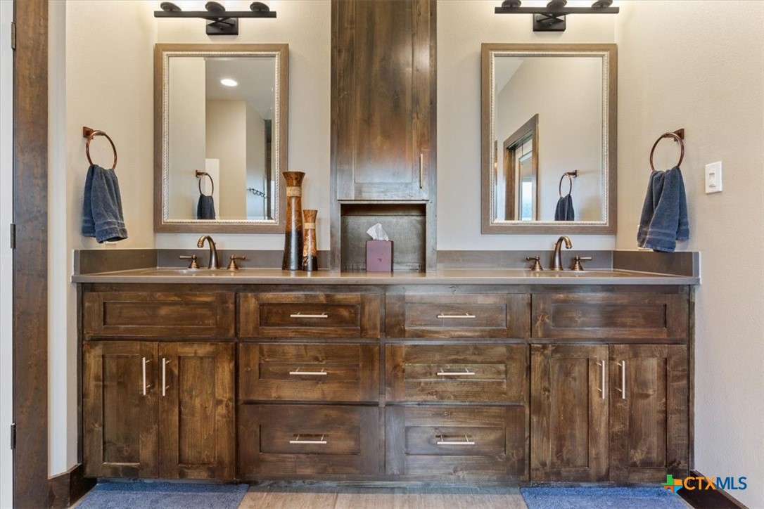 569 Messer Ranch Road Belton, TX 76513 - Photo 17 of 48 a bathroom with a granite countertop sink vanity and mirror