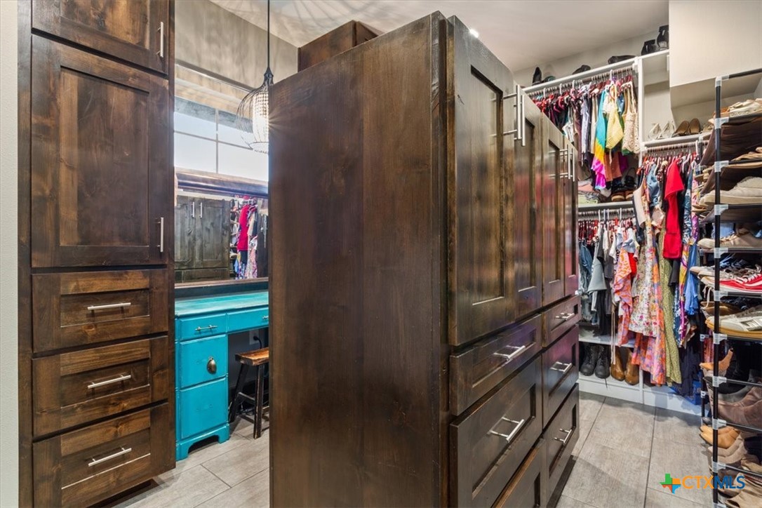 569 Messer Ranch Road Belton, TX 76513 - Photo 20 of 48 a view of walk in closet with clothes