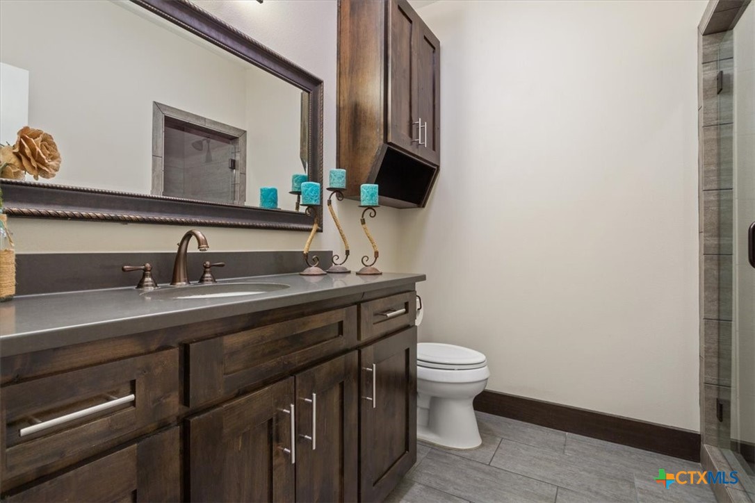 569 Messer Ranch Road Belton, TX 76513 - Photo 23 of 48 a bathroom with a toilet sink and mirror