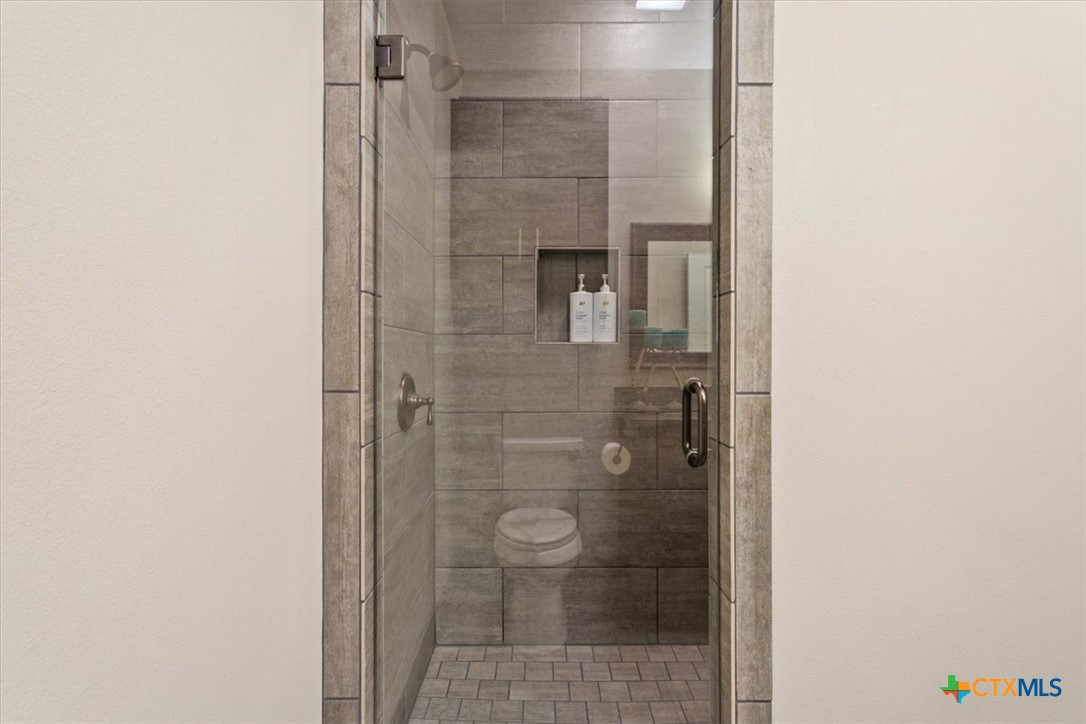 569 Messer Ranch Road Belton, TX 76513 - Photo 24 of 48 a bathroom with a glass shower door