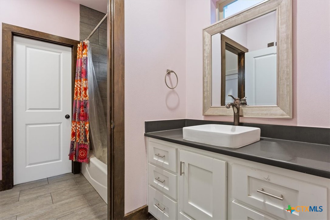 569 Messer Ranch Road Belton, TX 76513 - Photo 27 of 48 a en suite bathroom with a granite countertop sink and a mirror