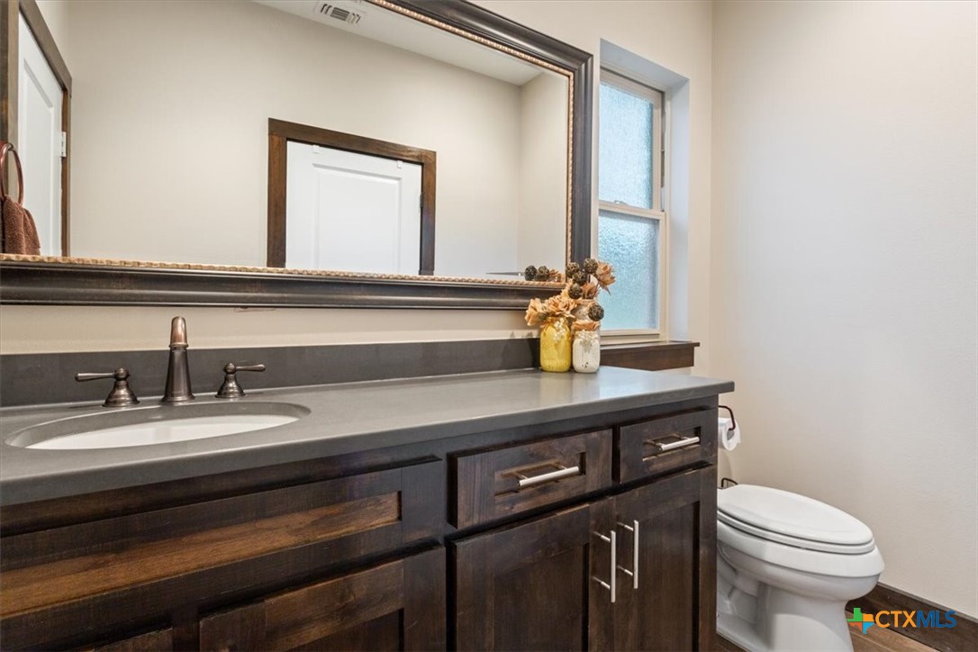 569 Messer Ranch Road Belton, TX 76513 - Photo 32 of 48 a bathroom with a sink a toilet and mirror