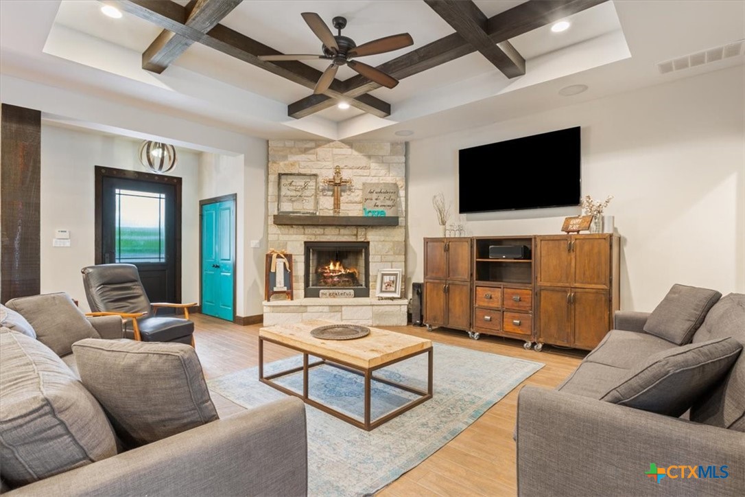 569 Messer Ranch Road Belton, TX 76513 - Photo 6 of 48 a living room with furniture a flat screen tv and a fireplace