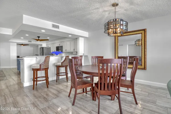 a view of a dining room with furniture wooden floor and chandelier