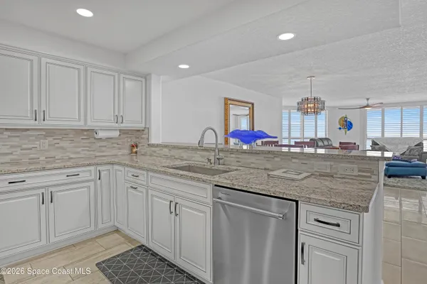 a kitchen with stainless steel appliances granite countertop a sink and cabinets