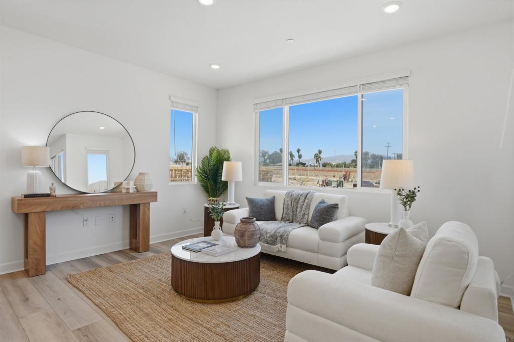2402 Cascalote Loop San Diego, CA 92154 - Photo 12 of 35 a living room with furniture and a wooden floor