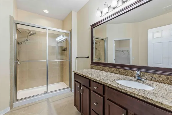 a bathroom with a granite countertop sink mirror and double