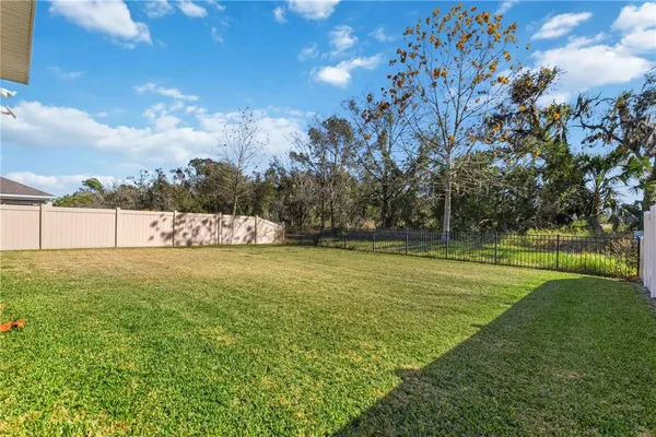 a view of a swimming pool with an outdoor seating and a yard