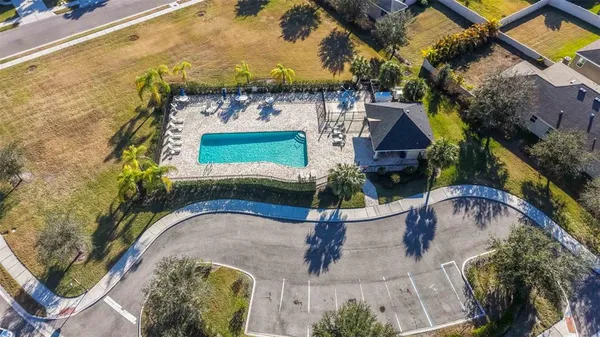 an aerial view of a house with garden space and swimming pool