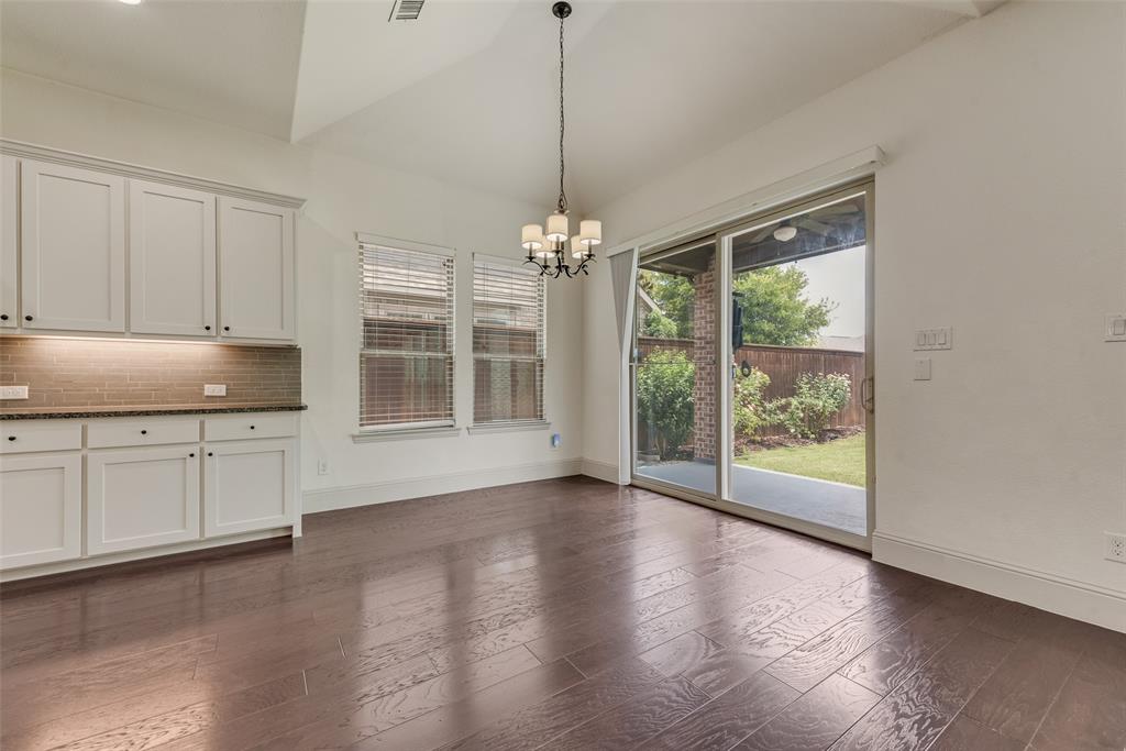 2021 Calisto Way Allen, TX 75013 - Photo 14 of 34 Spacious room featuring dark wood-finish flooring, white cabinetry with dark hardware, and a tile backsplash