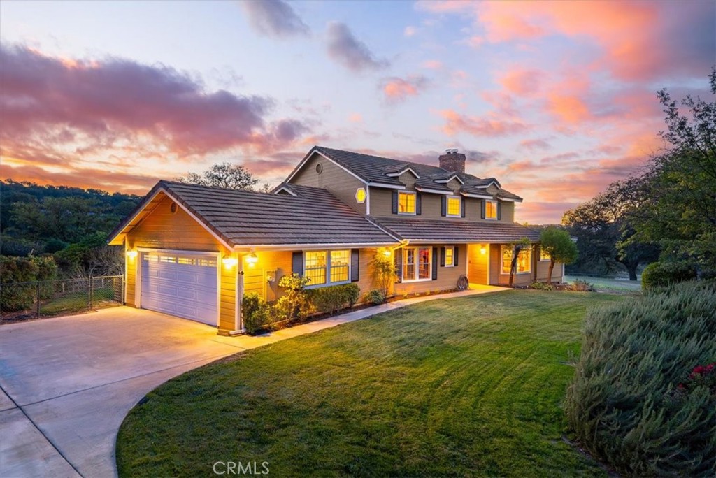 a front view of a house with a yard and potted plants