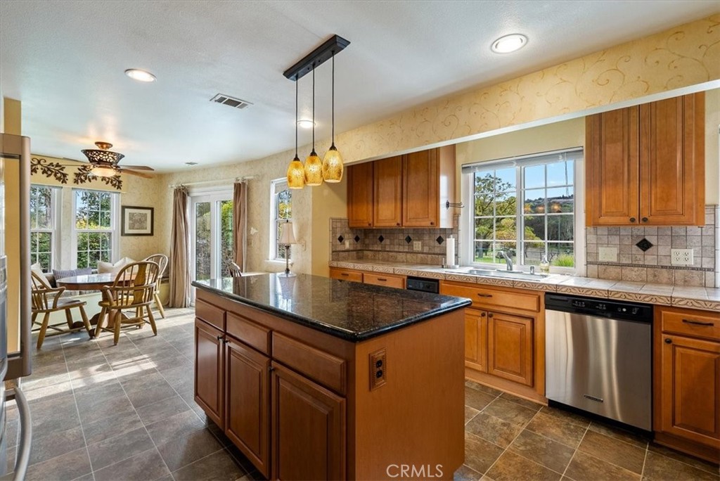 1505 Barley Grain Road Paso Robles, CA 93446 - Photo 14 of 56 a kitchen with stainless steel appliances granite countertop a sink and a large window