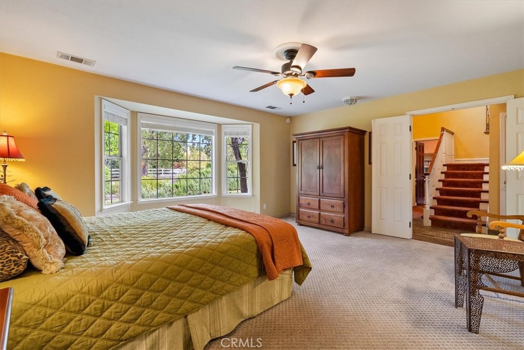 1505 Barley Grain Road Paso Robles, CA 93446 - Photo 19 of 56 a bedroom with a bed and a chandelier