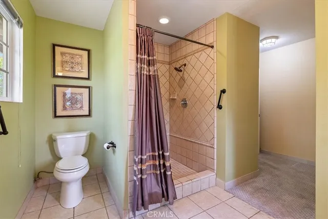 a living room with furniture a flat screen tv and a window