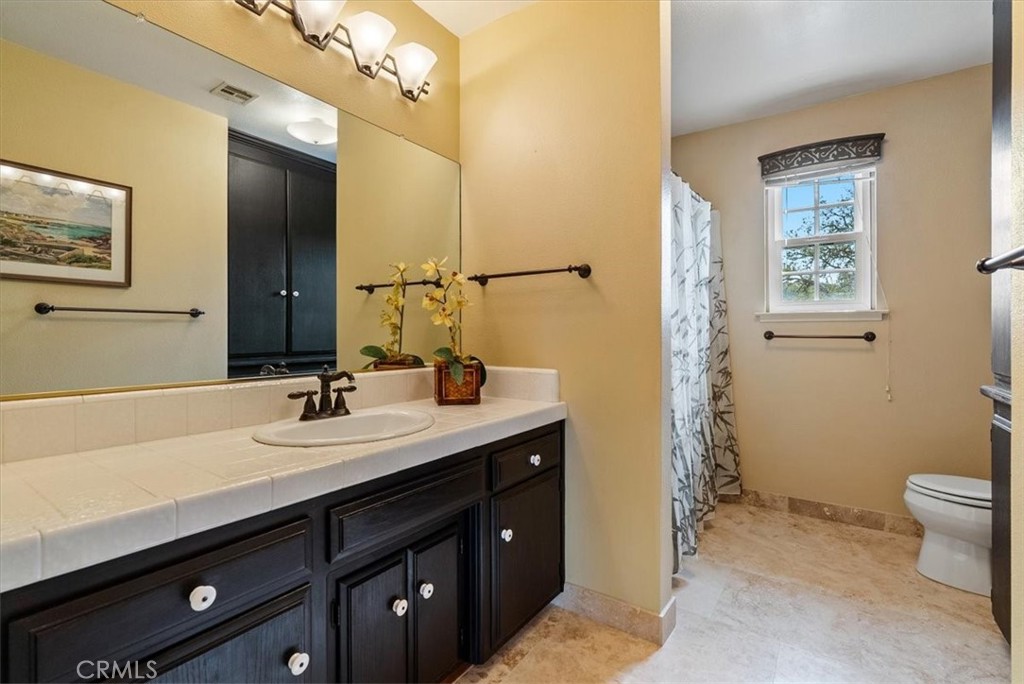 1505 Barley Grain Road Paso Robles, CA 93446 - Photo 30 of 56 a bathroom with a granite countertop sink toilet and mirror