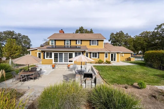 a swimming pool with outdoor seating and yard