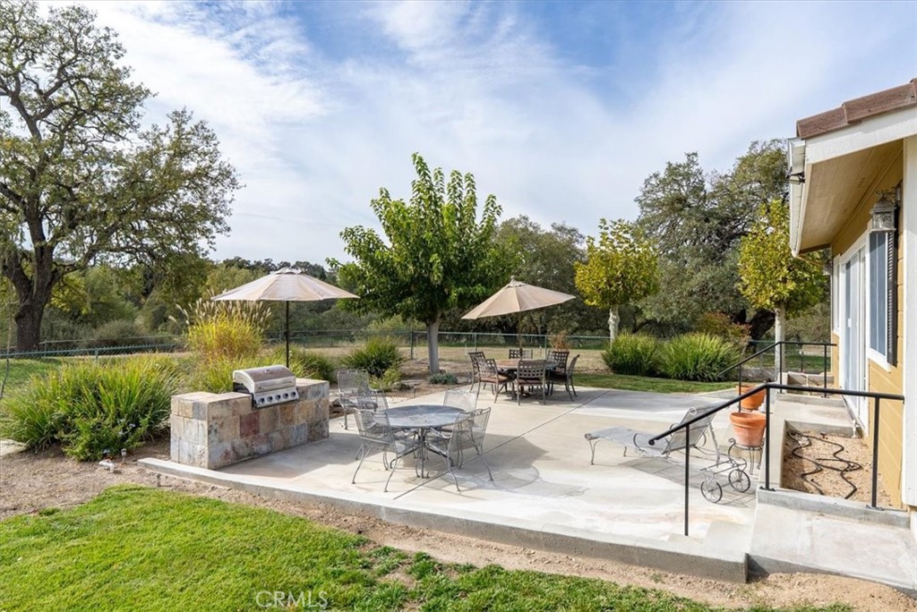 1505 Barley Grain Road Paso Robles, CA 93446 - Photo 36 of 56 a view of a patio with chairs and tables under an umbrella