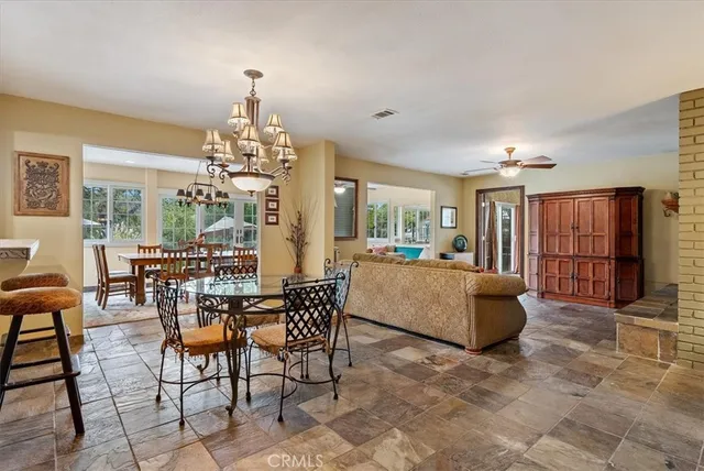 a view of a dining room with furniture and chandelier